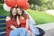 The bride with his girlfriend sitting in the park. Keep balloons