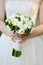 Bride is holding beautiful bright wedding bouquet