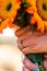 Bride holding a bouquet of colorful sunflowers