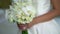 Bride holding bouquet with white rose flowers