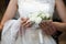 Bride is holding cute elegant exquisite wedding bouquet