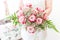 Bride Holding Fresh Pink Roses, Gypsophila and Fern Bouquet
