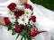 Bride holding her wedding bouquet against her dress