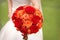 Bride holding orange bouquet