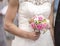 Bride holding pink and white wedding flowers