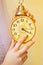 Bride holding a vintage alarm clock