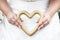 Bride holding wedding accessory in form of heart