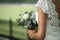 Bride holding wedding bouqet with white roses