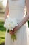 Bride holding wedding bouquet. White peony flowers. Classical elegance.