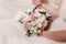 Bride is holding a wedding colorful bouquet. Beauty of colored flowers. Close-up bunch of florets. Bridal accessories. Female