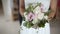 Bride holding wedding flowers in hands