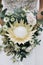 The bride holds beauty wedding bouquet of protea flowers