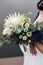 The bride holds beauty wedding bouquet of white protea flowers