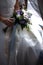 Bride holds a bouquet of white and blue asters