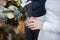 Bride holds bridal bouquet