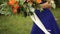 The bride holds in her hand a wedding bouquet of roses, hydrangeas, Hypericum and eucalyptus branches