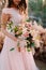 A bride holds rustic wedding bouquet consisting of different flowers. Decoration Artwork