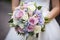 The bride holds soft wedding bouquet of roses, peonies and eustoma. Generative AI