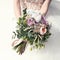 Bride holds a wedding bouquet, wedding dress , wedding details. Wedding ceremony concept.