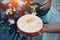 Bride holds wooden stand with golden weding rings. A touching moment at the ceremony. Rings on round wooden stand, close up