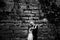 Bride hugs groom tenderly standing alone behind an old castle