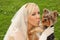 Bride keeps and kisses small dog