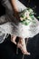 A bride laying on the floor in a beautiful dress holding a bouquet