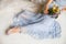 A bride laying on the floor in a beautiful dress holding a bouquet