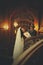 Bride leans on stair railing in the wooden hall