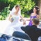 Bride looks funny while bridesmaid adjusts an earring