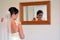 Bride looks at herself in the mirror on her Wedding Day