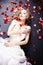 Bride lying among rose petals