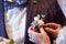 The bride pin small butanerku on the jacket the groom