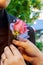 Bride pins a boutonniere to groom\'s blue jacket