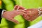 A bride places a ring on the grooms hand