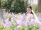 Bride portraint with white wedding dress in Orychophragmus violaceus flower field