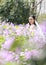 Bride portraint with white wedding dress in Orychophragmus violaceus flower field