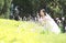 Bride portraint with white wedding dress in Orychophragmus violaceus flower field