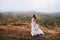 Bride posing in high mountain scenery