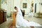 Bride prays on the knees standing in the front of an icon in the