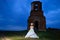 Bride prays near an old ruined church