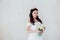 Bride Princess stands in a wedding dress with flowers