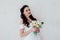 Bride Princess stands in a wedding dress with flowers
