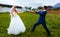 Bride pulling her groom to her with a rope - funny wedding concept.