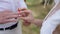 the bride puts the ring on the groom's finger on forest location