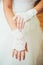 Bride puts on wedding gloves