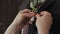 Bride putting on flower boutonniere