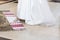 bride putting leg on traditional embroidery towel in church during holy matrimony. wedding ceremony concept