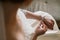 Bride putting on luxury bracelet on hand in the morning, getting ready.