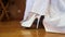 Bride Raises Wedding Dress Baring Feet in Tights Shoes Closeup